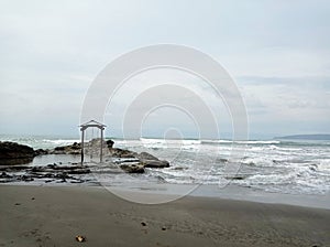 the swing on the beach is occasionally hit by the waves