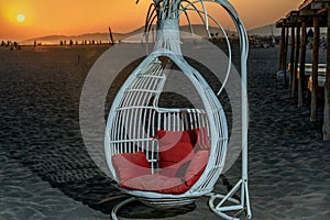 The swing on the beach in the sunset