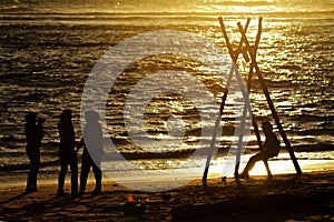 Swing on the beach at sunset