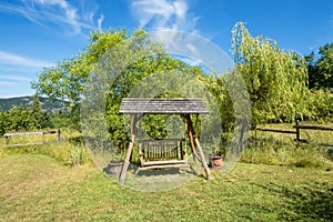 Swing bench in a lush garden