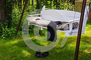 Swing bench in lush garden