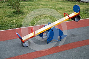 Swing bright color in the form of a Dolphin on the Playground with rubberized surface.