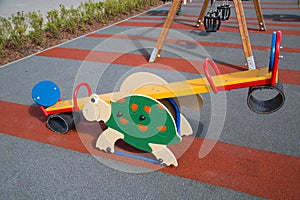 Swing bright color in the form of a turtle on the Playground with rubberized surface.