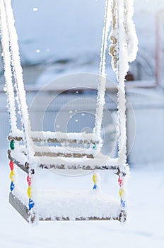 Swing covered with frost in the winter Park