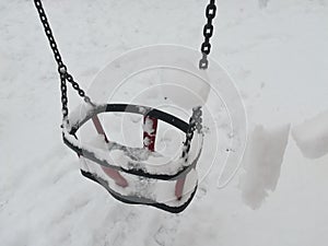 Swing covered with snow