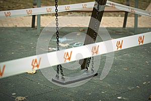 Swing in a kids playground cordoned off photo