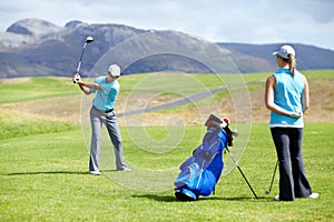 Swing, man or golfer playing golf for fitness, workout or exercise to drive on a green course. Woman, person golfing or