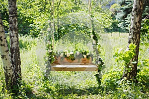 Swing overgrown with flowers