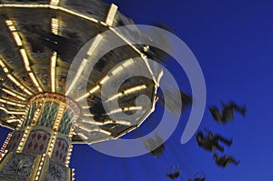 Swing ride at fair spinning around at twilight