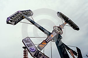 Swing ride going around at a fair. entertainment amusement park