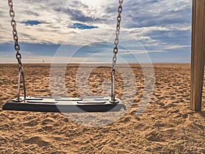 Swing on sandy ground in countryside