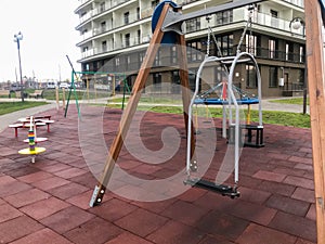 Swing for small children in the courtyard of the residential complex. high chair for rocking the baby. active rest with children