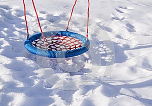 Swing on winter playground