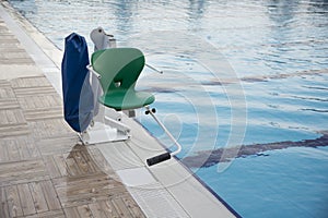 Swinging arm disabled chair. Swimming pool lift with a chair