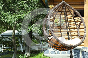 Swinging bench and hammock in the garden,