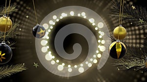 Swinging black and gold baubles over ring of yellow christmas lights on dark background