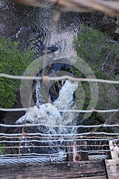 The swinging bridge does just that as the photographer makes his way across the river