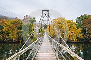 Swinging bridge over the James River and fall color in Buchanan, Virginia