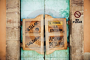 Swinging doors with spanish text on door. Billiard. No entrance for children under 18