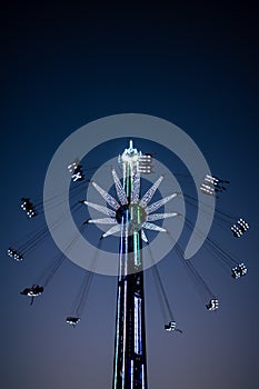 Swinging into the Night: Captivating Blue Hour Photos of the Thrilling Swing Ride