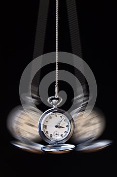 Swinging pocket watch hypnosis on black