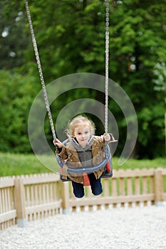 Swinging preschooler having fun