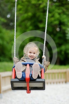 Swinging preschooler having fun