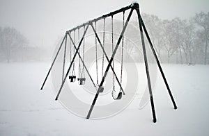 Swings covered with snow photo