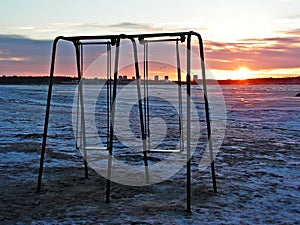 Swings on empty beach photo