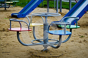 Swings in the park for children. Children`s playground bright colorful. Colorful children`s swing in playground. Children`s iro