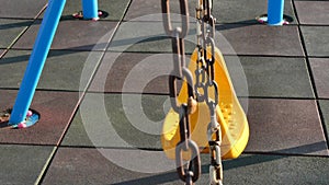 The swings in the playground are swinging. Empty swing in playground, kidnapping concept. . loneliness concept.