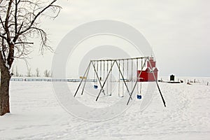 Swingset with light house in the background