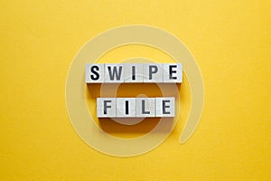 Swipe file - word concept on cubes,text