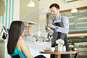 Swiping credit card in a coffee shop photo