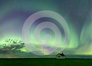 Swirl of Aurora Borealis Northern Lights over Historical School near Kyle, Saskatchewan, Canada