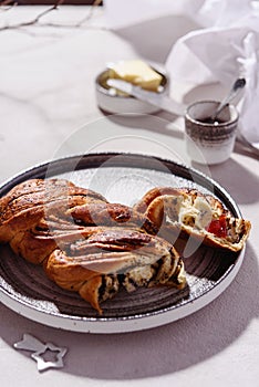 Swirl brioche with poppy seeds served with butter and jam