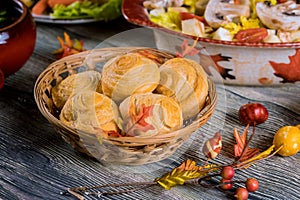 Swirl buns on wicker basket with autumn decoration