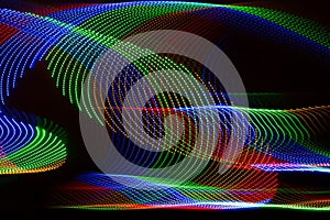 Swirl of lights in blue green and red with a black background