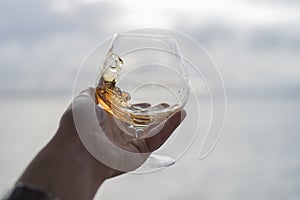 Swirling brandy in glass