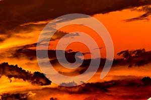 Swirling evening clouds illuminated by the setting sun