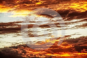 Swirling evening clouds illuminated by the setting sun