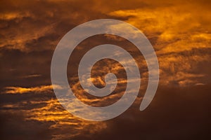 Swirling evening clouds illuminated by the setting sun