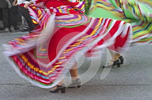 Swirling Mexican dance dresses on street