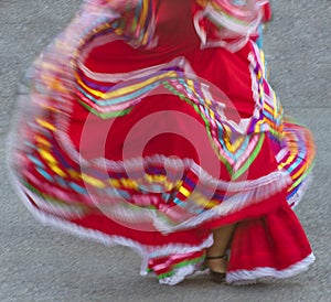 Swirling red Mexican dance dress on street