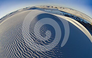 Swirling ridges and textured patterns of sand accentuate a more global perspective of White Sands National Monument.