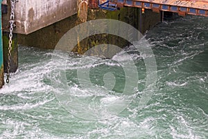 The swirling water as the ferry leaves its port.