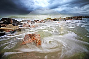 Swirling wave at Teluk Ketapang beach photo