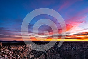 Swirls of Sunset Colored Clouds Over the Rim of the Grand Canyon