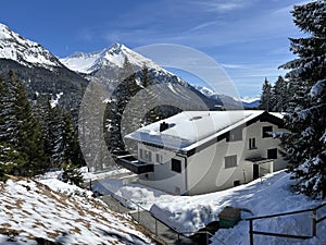 Swiss alpine holiday homes, mountain villas and holiday apartments in the winter ambience of the Alpine tourist resorts