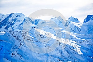 Swiss alps with blue snow